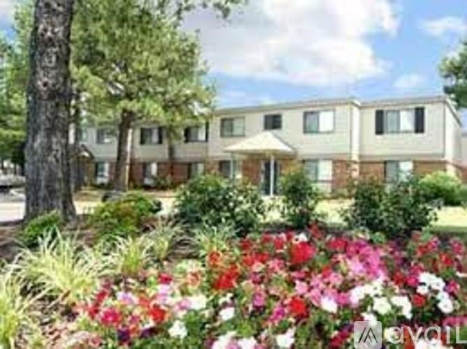 A building with a garden in front of it.