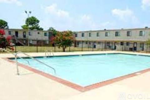A swimming pool in front of apartment buildings.