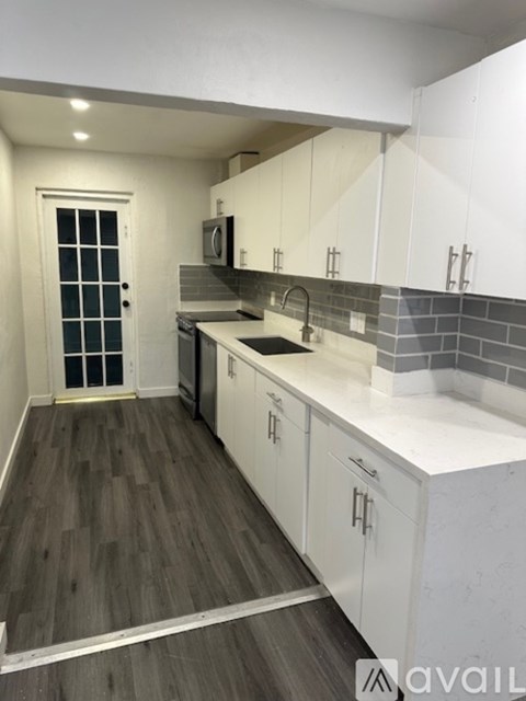 A living room with a white couch and a television.