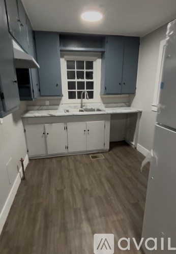 A kitchen with a window above the sink.