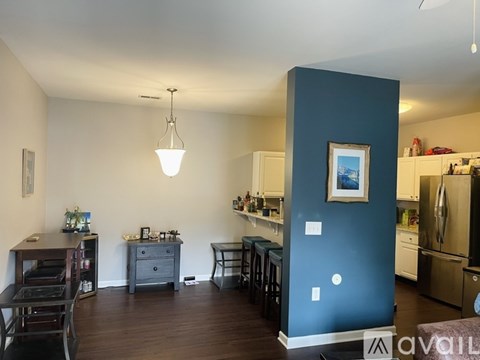 A kitchen with a blue wall and white appliances.