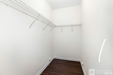 Empty room with a shelf and a wooden floor.