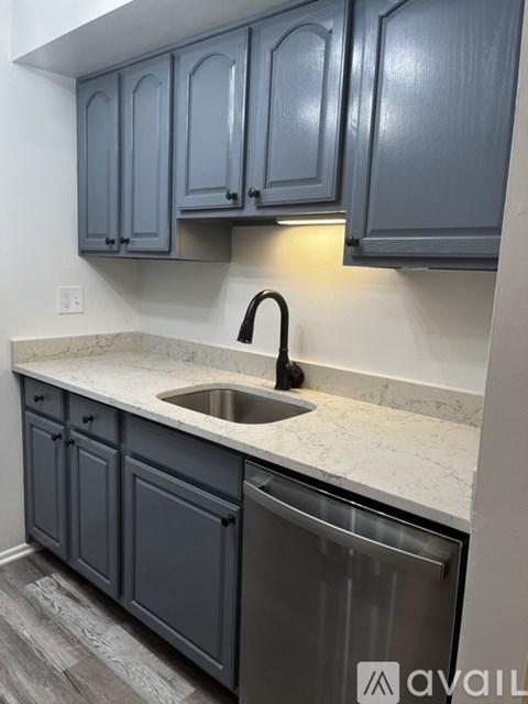A kitchen with a sink and cabinets.