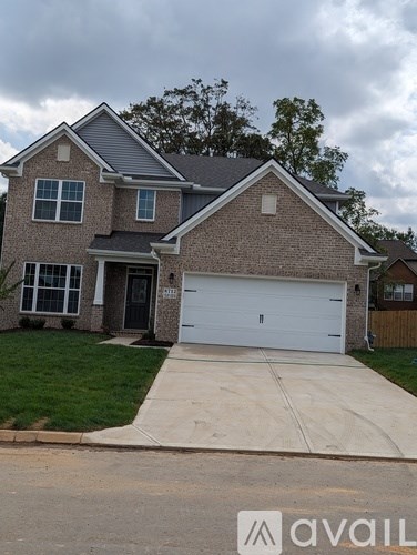 A two-story house with a garage is available for sale.