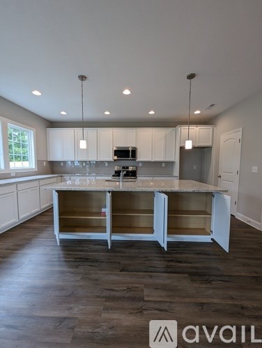 A kitchen with a large island in the middle.