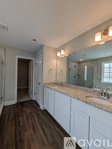 A bathroom with a vanity and a large mirror.