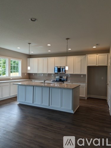 A kitchen with a large island in the middle.