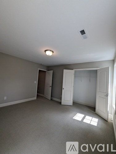 A room with a carpeted floor and a ceiling light.