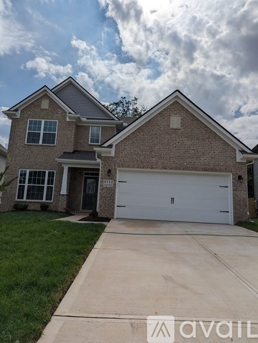A two-story house with a garage is for sale.