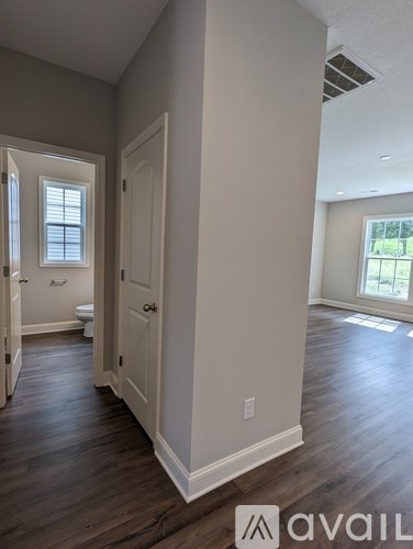 A room with a wooden floor and a window.