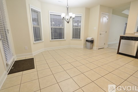 A kitchen area with a dishwasher and a fridge.