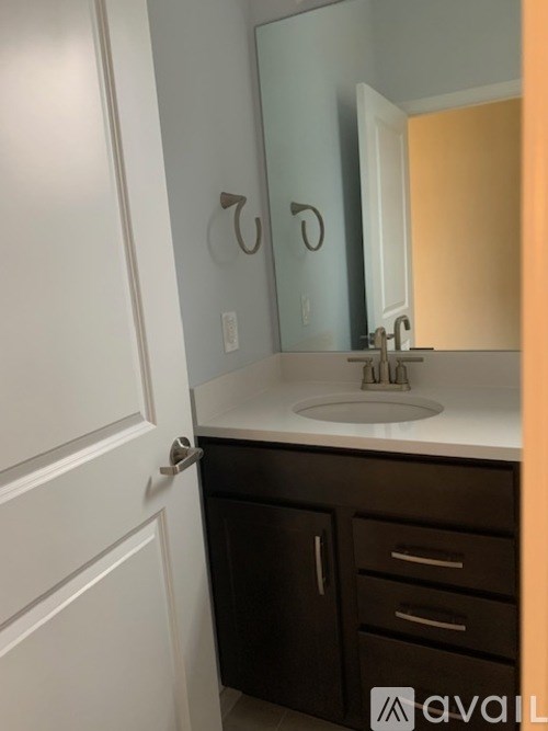 A bathroom with a sink and a mirror.