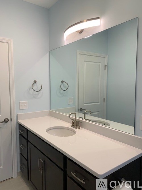 A bathroom with a sink and mirror.