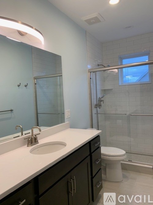 A bathroom with a white countertop and a toilet.