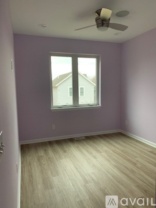 A room with purple walls and a window.