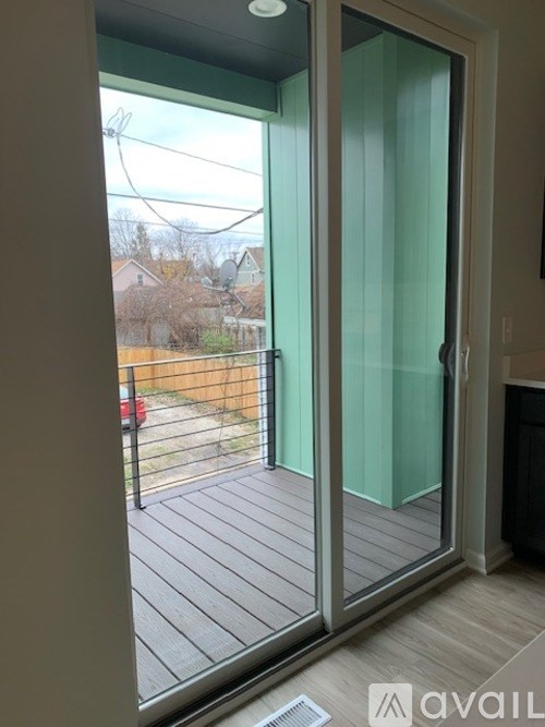 A glass door with a black handle and a window on the left.
