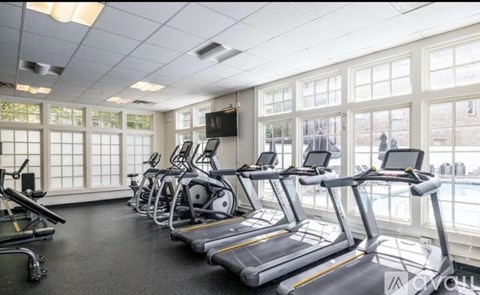 A gym with treadmills and elliptical machines.