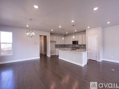 A spacious kitchen with white cabinets and a large island.