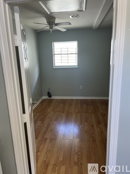 A room with a window and a ceiling fan.