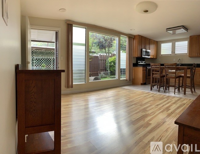A kitchen with wooden floors and a wooden cabinet.