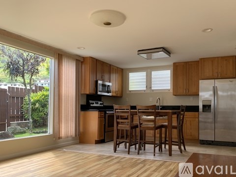 A kitchen with wooden cabinets and a dining table.