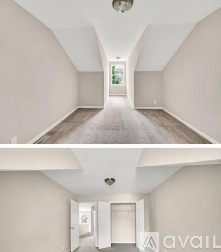 A hallway with a carpeted floor and white walls.
