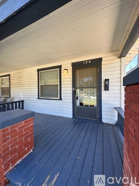 A white house with a black door and windows.