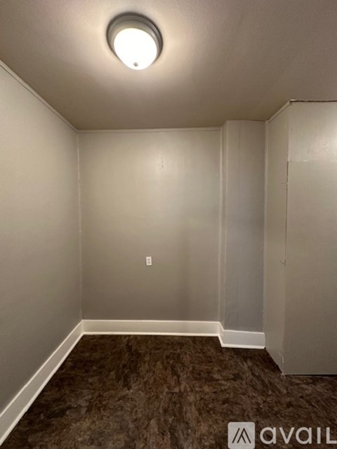 A room with a carpeted floor and a ceiling light.