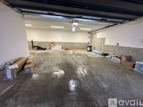 A large, empty warehouse with concrete floors and exposed ductwork.