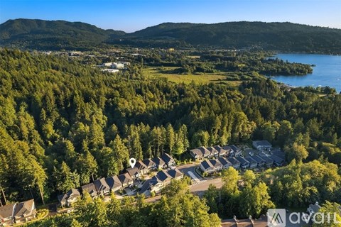 A bird's eye view of a resort surrounded by trees and a lake.