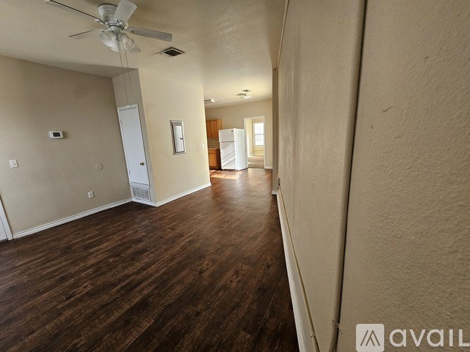 A room with wooden floors and a ceiling fan.