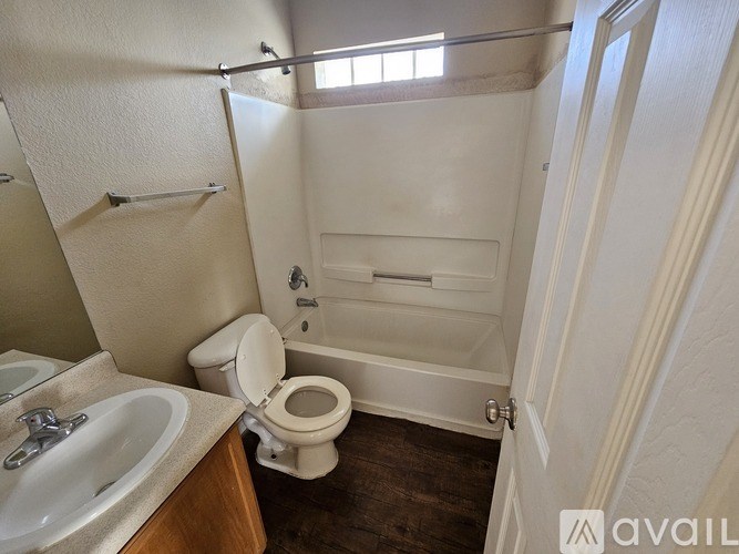 A small bathroom with a toilet, sink, and bathtub.