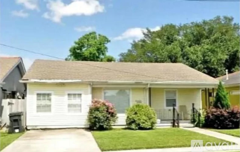 A house with a white garage door and a brown roof.