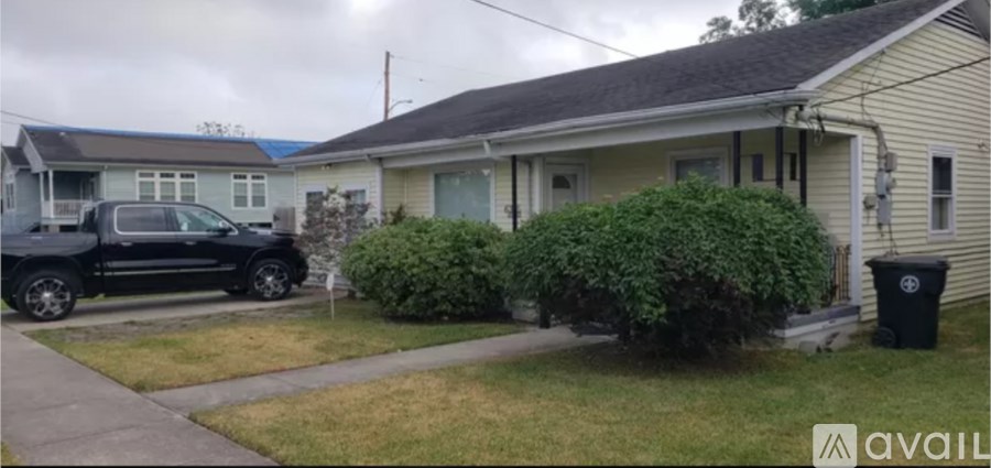 A black pickup truck is parked in front of a house.