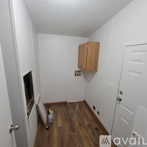 A room with a wooden floor and white walls.