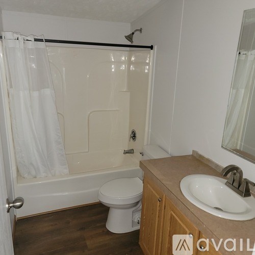 A bathroom with a toilet, sink, and bathtub.