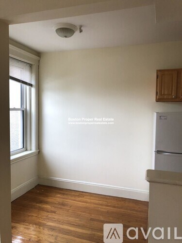 A room with wooden floors and a window.
