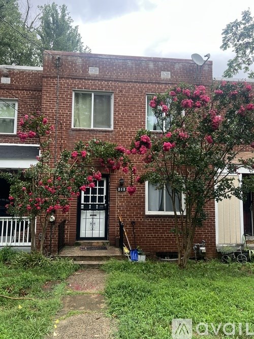 A brick house with a white door and windows.