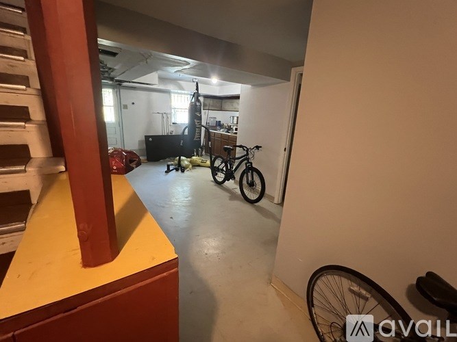A room with a bicycle and a TV in the background.