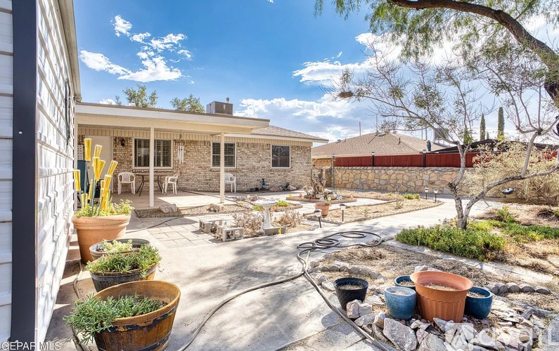A backyard with a patio and a fire pit.
