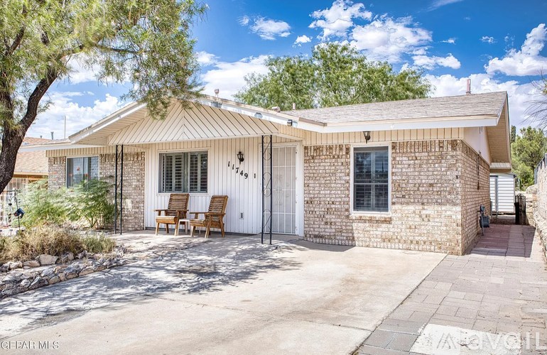 A house with a white fence and a white garage door.