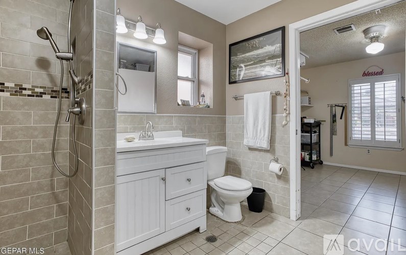 A bathroom with a white toilet and sink.