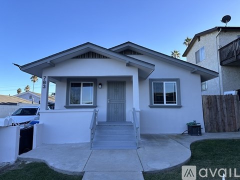 A house with a car parked in front of it.
