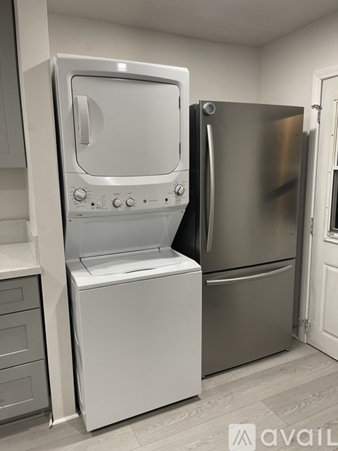 A stainless steel refrigerator and oven in a kitchen.