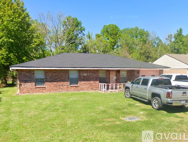A house with a grey truck parked in front.