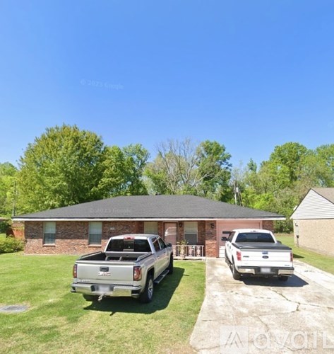 A house with two trucks parked in front.