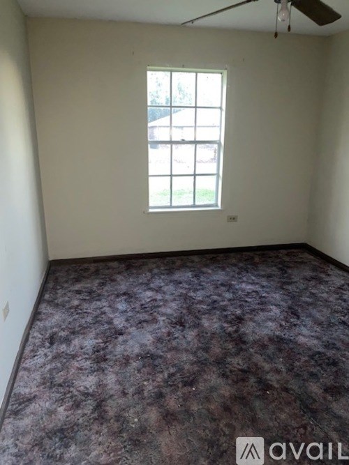 A room with a purple floor and a window.