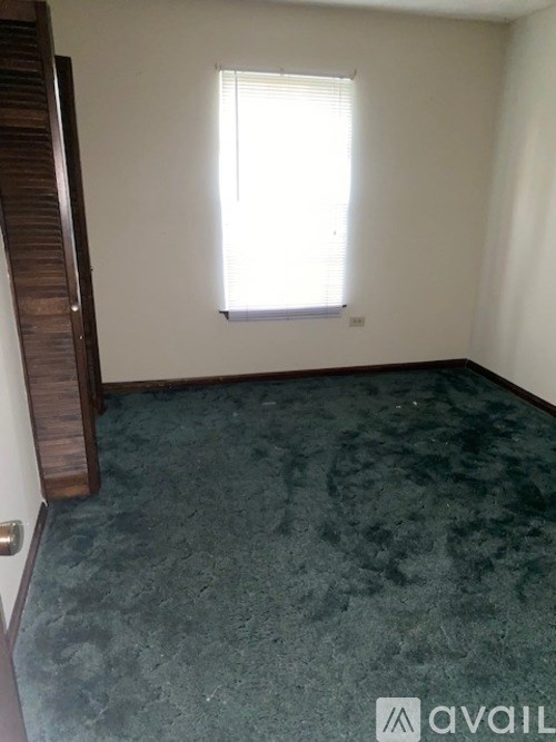 A room with a window and a door.