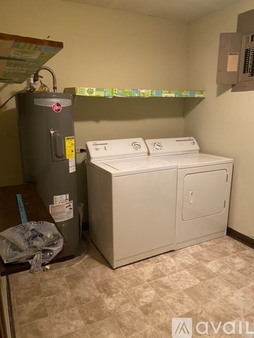 A room with a washer and dryer.