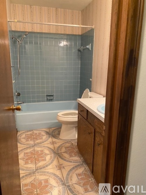A bathroom with a toilet, sink, and shower.